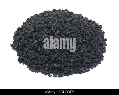 Heap of black cumin or black caraway seeds on a white background. Also called kalonji seeds. Stock Photo