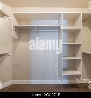 Square frame Small walk in closet with hanging rods and shelves Stock ...