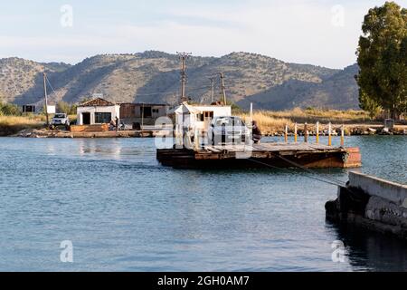 Butrint, Albania. Cable ferry crossing the Vivari Channel with a car ...