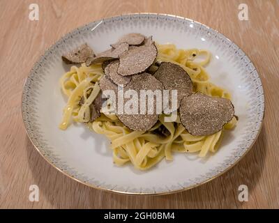 Tagliatelle al Tartufo Nero, Black Truffle Pasta Side View Stock Photo