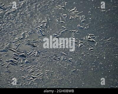 sunshine on numerous random three dimensional geometric shapes in ice pattern on frozen puddle in upland fells in Winter - Cumbria,England,UK Stock Photo