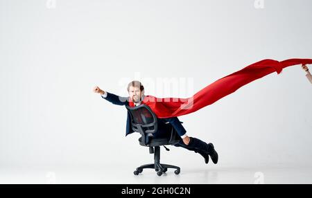business man with red cloak trying in superman office chair Stock Photo ...
