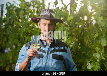 man hold wine glass, bearded guy in office style clothes at restaurant,  sommelier near woman in mirror Stock Photo - Alamy