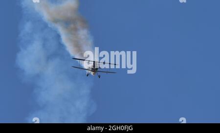 Ferrara Italy JUNE, 27, 2021 Dangerous air performance in flight of a retro biplane. Christen Pitts S-2B Special Stock Photo