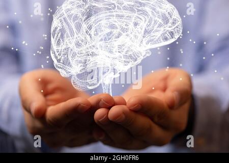 Digital concept of a human brain anatomical model floating on the hand Stock Photo