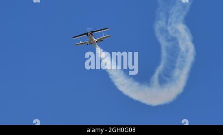 Ferrara Italy JUNE, 27, 2021 Small vintage biplane Christen Pitts S-2B Special with smoke in flight Stock Photo