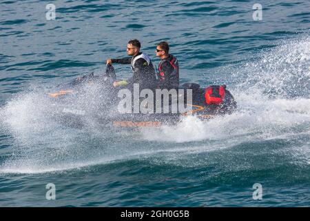 Bournemouth, Dorset UK. 3rd September 2021. UK weather: warm and sunny at Bournemouth, as visitors have fun on the sea whilst enjoying the Bournemouth Air Festival.  Men riding jetski jet ski. Credit: Carolyn Jenkins/Alamy Live News Stock Photo