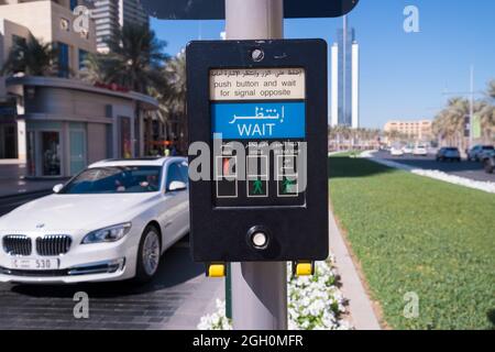 A typical walk, don't walk, wait traffic signal box for pedestrians at a  street intersection crosswalk. In Dubai, United Arab Emirates. Stock Photo