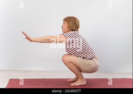 https://l450v.alamy.com/450v/2gh0n7t/elderly-woman-doing-squats-on-a-white-background-the-old-lady-is-doing-exercises-for-her-health-2gh0n7t.jpg