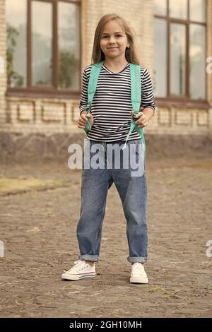 Making childhood interesting. Preschool child carry backpack outdoors. Small kid back to school. Preschool education. Afterschool club. Daycare. Day n Stock Photo