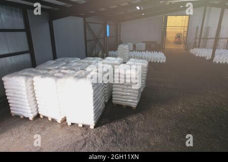Pallets with white bags in warehouse above top view Stock Photo