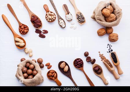 Hemp Sack bags and spoon of various legumes and different kinds of nuts walnuts kernels ,hazelnuts, almond kernels,brown pinto ,red kidney beans and p Stock Photo