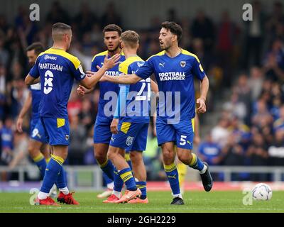 AFC Wimbledon's Will Nightingale (right) celebrates the assist on their side's first goal of the game, scored by Jack Rudoni (not pictured) during the Sky Bet League One match at Plough Lane, London. Picture date: Saturday September 4, 2021. Stock Photo