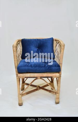 cane dining chair with blue cushion on the white background selective soft focus Stock Photo