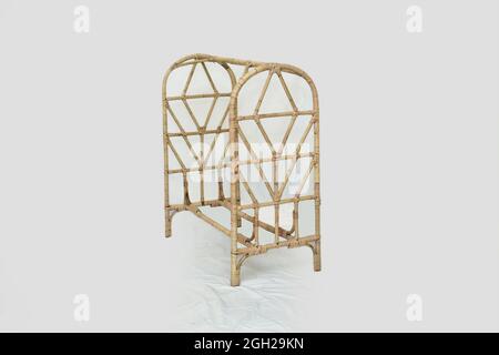 rattan cane kids clothes rack with white background and  selective  focus Stock Photo