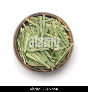 Top view of dried lemongrass herb in wooden bowl isolated on white Stock Photo