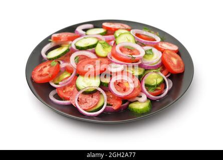Raw tomatoes cucumber vegetable salad isolated on white Stock Photo