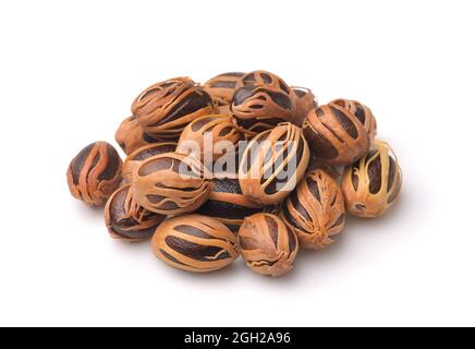 Pile of whole nutmeg with mace isolated on white Stock Photo