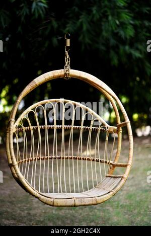 wing chair in the garden with a half round shape from wicker stock photo Stock Photo