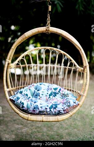 wing chair in the garden with a half round shape from wicker stock photo Stock Photo