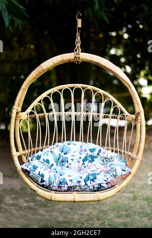 wing chair in the garden with a half-round shape from wicker stock photo Stock Photo