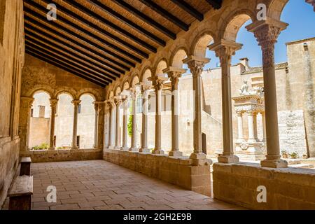 August 10, 2021 - Abbey of Santa Maria a Cerrate, Puglia, Salento, Lecce - The portico at the side of the church, shady and cool, with arches and colu Stock Photo