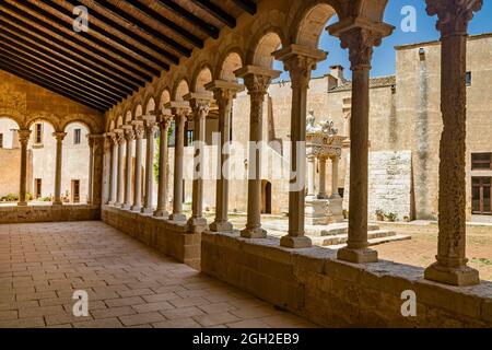 August 10, 2021 - Abbey of Santa Maria a Cerrate, Puglia, Salento, Lecce - The portico at the side of the church, shady and cool, with arches and colu Stock Photo