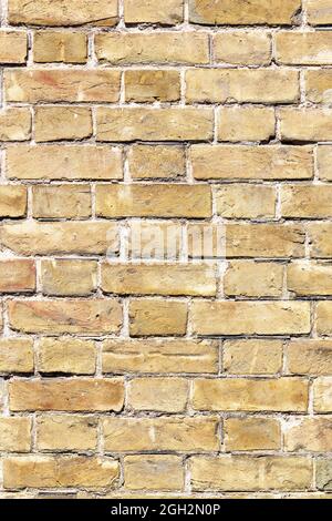 Weathered brick wall texture background in sunlight. Vertical image. A high resolution. Stock Photo