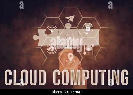 Handwriting text Cloud Computing. Word for storing and accessing data and programs over the Internet Hand Holding Jigsaw Puzzle Piece Unlocking New Stock Photo