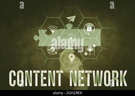 Text sign showing Content Network. Business idea A group of Web sites that agree to show ads on their site Hand Holding Jigsaw Puzzle Piece Unlocking Stock Photo