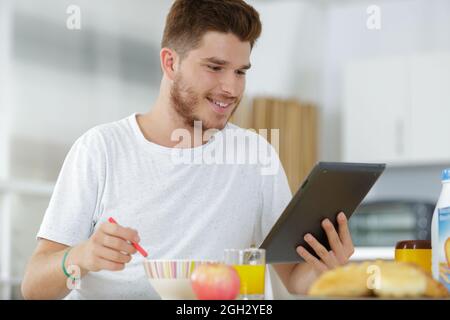 happy young man using digital tablet computer Stock Photo
