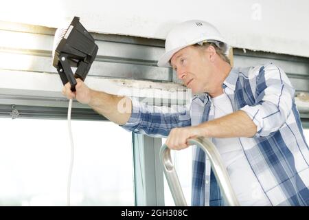 senior man checking the state of a window Stock Photo