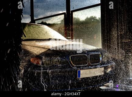 blue car in automatic washing Stock Photo