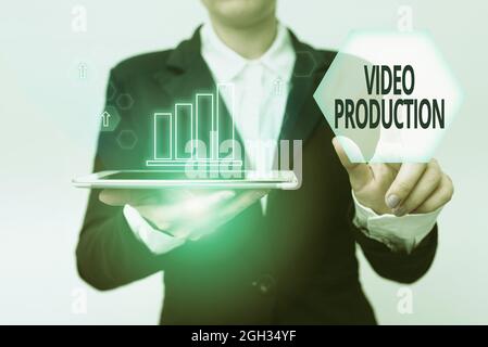 Writing displaying text Video Production, Word for process of converting an idea into a video Filmaking Woman In Suit Holding Tablet Pointing Finger O Stock Photo