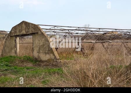 Abandoned greenhouses. Destroyed greenhouse of a ruined hothouse economy. Abandoned greenhouse. Frame greenhouses without glass and film. Stock Photo