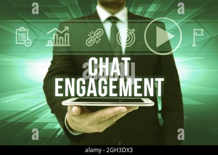 Inspiration showing sign Chat Engagement, Business approach customer interacts directly with a brand by conversation Man In Office Uniform Holding Tab Stock Photo