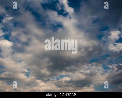 dramatic gray clouds in a blue sky Stock Photo