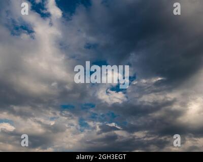 dramatic gray clouds in a blue sky Stock Photo