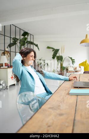 Woman finishes the job. Business woman working remotely online. At the end of the work celebrating happy and satisfied. Stock Photo
