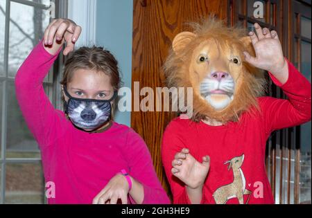 Two girls model animal masks in this funny photo Stock Photo