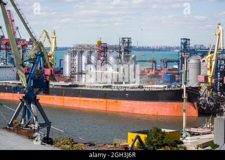 Ship dry cargo in port for loading grain. Vessel bulk carrier loading grain in port at grain terminal. Vessel dry cargo on loading, unloading in port. Stock Photo