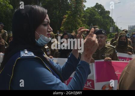 Lahore, Pakistan. 04th Sep, 2021. Pakistani traffic police women ride their motorbikes and others take a part during the women safety and empowerment march rally in Lahore. Punjab Police launches a women safety app and anti women harassment cell help line no 1242. (Photo by Hussain Ali/Pacific Press) Credit: Pacific Press Media Production Corp./Alamy Live News Stock Photo