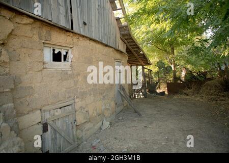 Part of Ruined old house. Ruins of a house made of shell rock, straw and clay in the village. Poor old village. Stock Photo