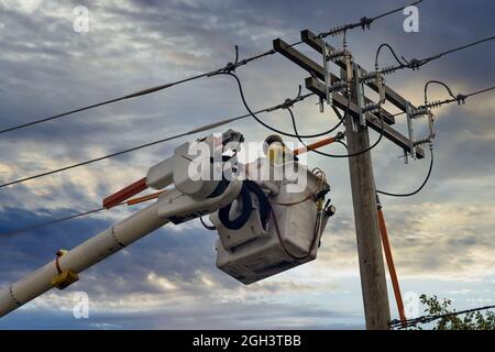 Engineering check working on high-voltage tower on after tornado Stock Photo