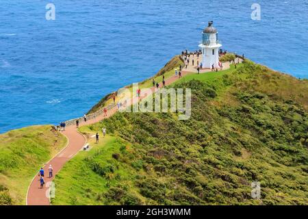 Cape Reinga in the far north of New Zealand. Tourists make their way to the iconic lighthouse Stock Photo