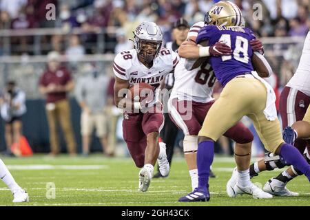 Montana Grizzlies running back Isiah Childs (28) runs with the ball during the fourth quarter of an NCAA college football game against the Washington Stock Photo