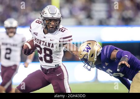 Montana Grizzlies running back Isiah Childs (28) runs with the ball during the fourth quarter of an NCAA college football game against the Washington Stock Photo