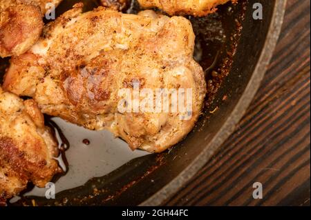 Fried pieces of meat in a frying pan, close-up, selective focus Stock Photo