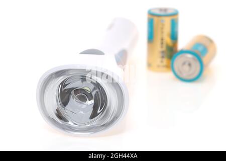 Electric led pocket flashlight with dry cell isolated on white background Stock Photo