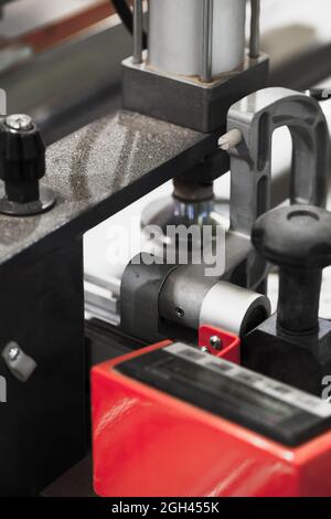 Workpiece clamping device on a CNC milling machine, close-up abstract industrial photo with selective soft focus Stock Photo